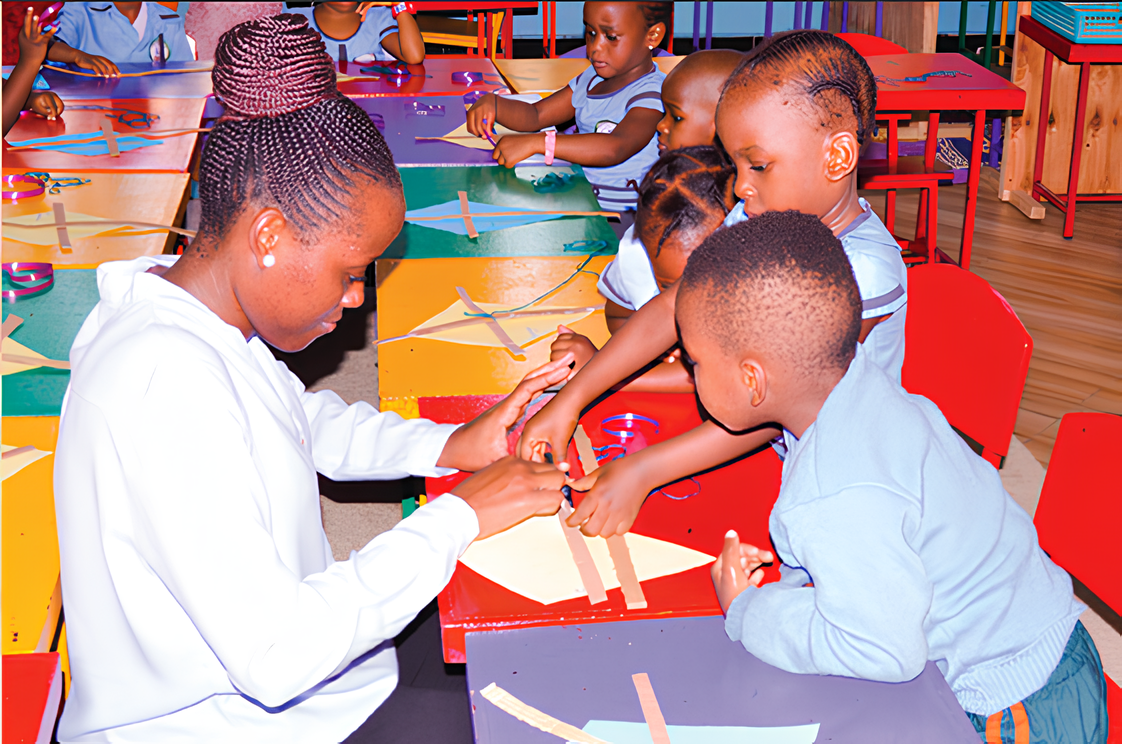 A Jubilation teacher helping children with a classroom activity
